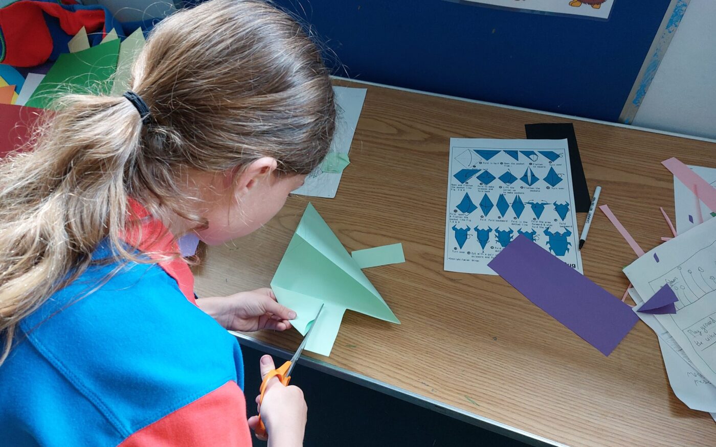 GIrlguide making origami beetles