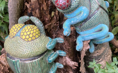 Conceptual ceramic interpretations of wood boring beetles against the backdrop of a decaying beetle inhabited cherry tree stump.